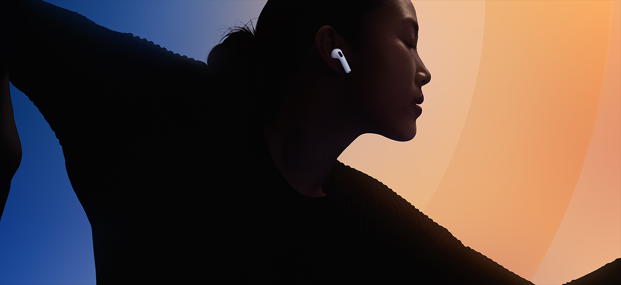 AirPods 5, white color, worn in the ear, person silhouetted against multi-color background